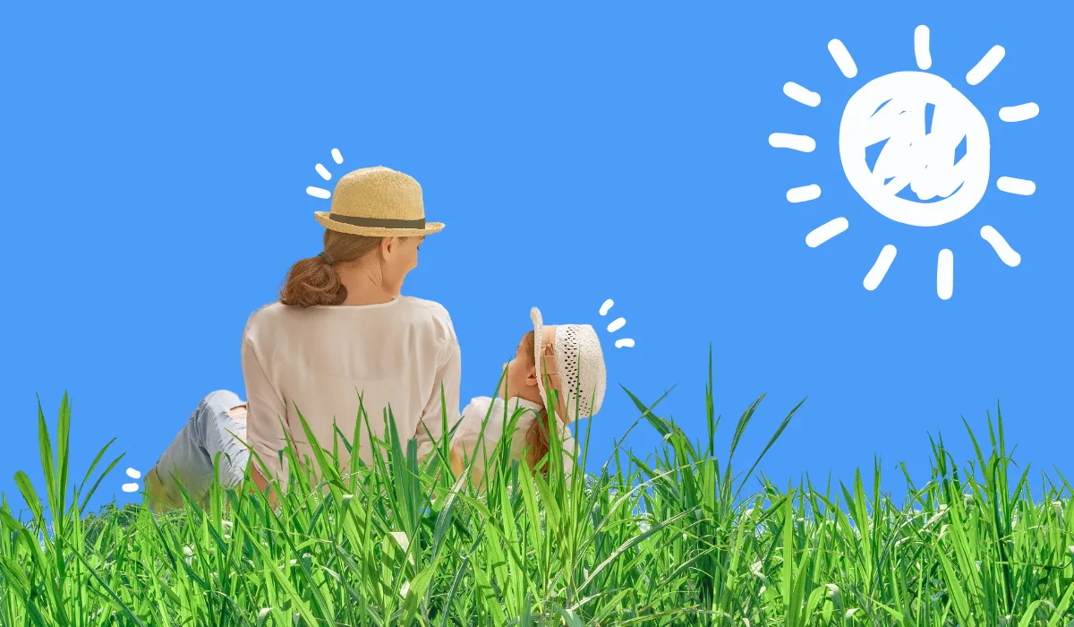 Femme et enfant assis dans l’herbe sous un soleil d’été – illustration de conseils santé été en plein air
